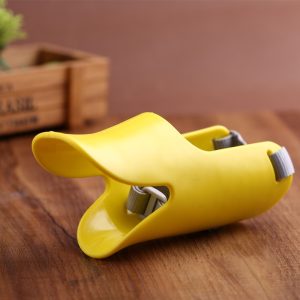 Yellow banana-shaped holder stand with whimsical design, perfect for wooden surfaces.