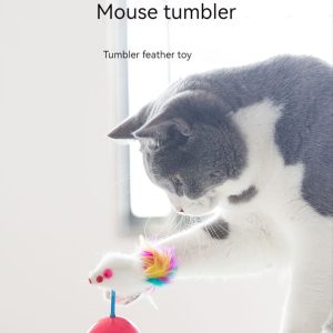 Playful cat engaged with Mouse Tumbler feather toy near window in brightly lit room.