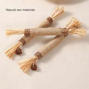 Handmade natural fiber brushes with dried botanical details and shell ornaments on plate.