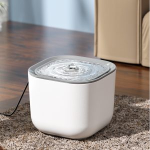 Modern white pet water fountain on cozy carpet in home environment with gentle bubbling water.